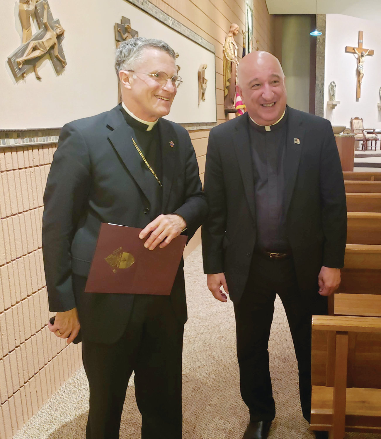Archbishop Timothy Broglio, left, shepherd of the Archdiocese for the Military Sevices, USA, and Father Robert Marciano, former U.S. Air National Guard chaplain and now pastor of St. Kevin and St. Benedict Parish, Warwick, and president of Bishop Hendricken, gather for a Catholic Schools retreat on Aug. 30.